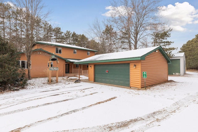 view of front facade with an outbuilding and a garage