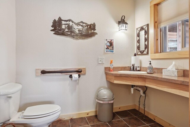 bathroom with tile patterned floors, sink, and toilet