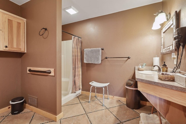 bathroom with tile patterned flooring, vanity, and a shower with shower curtain