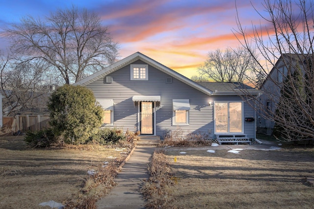 view of front of home with entry steps and fence