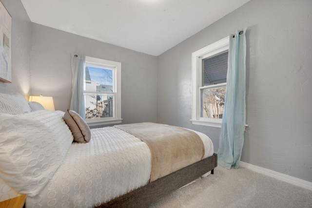 carpeted bedroom with baseboards