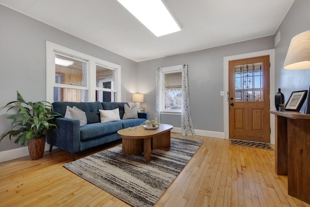 living room featuring light wood-type flooring and baseboards