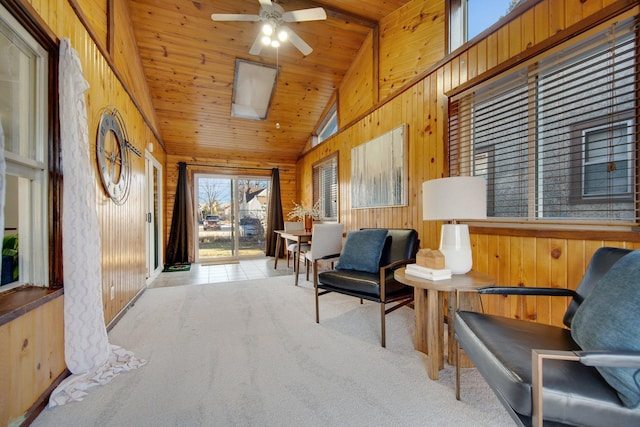 sitting room featuring wooden walls, wood ceiling, ceiling fan, carpet flooring, and high vaulted ceiling