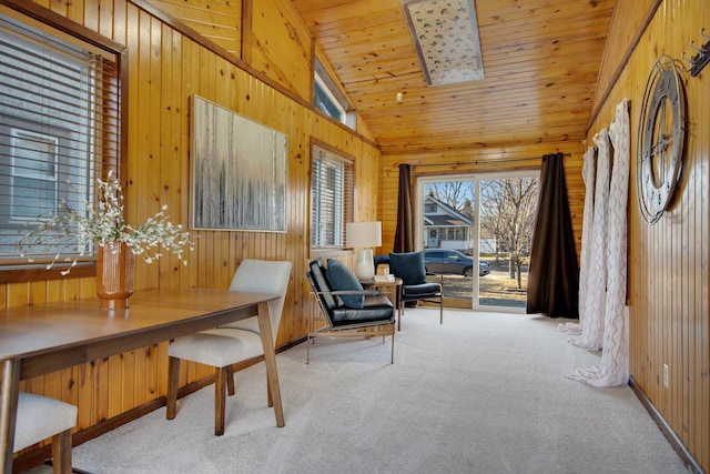 living area featuring wood walls, vaulted ceiling, carpet, and wooden ceiling