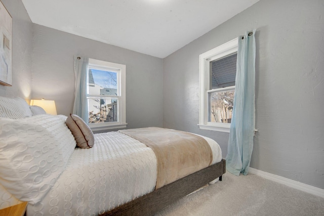bedroom featuring carpet flooring and baseboards
