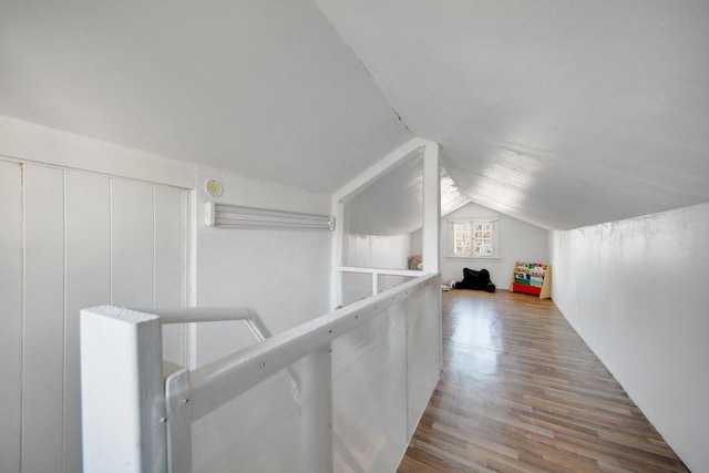 corridor with vaulted ceiling and wood finished floors