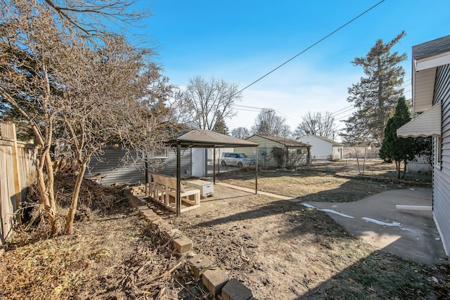fenced yard with a gazebo