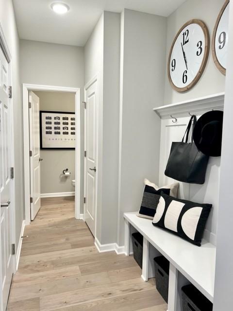 mudroom with light hardwood / wood-style flooring