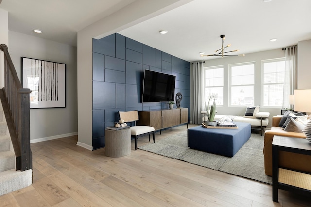 living room featuring an inviting chandelier and light wood-type flooring