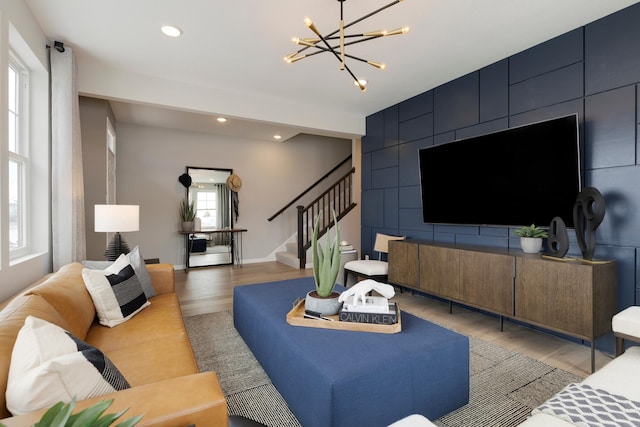 living room featuring wood-type flooring and a chandelier