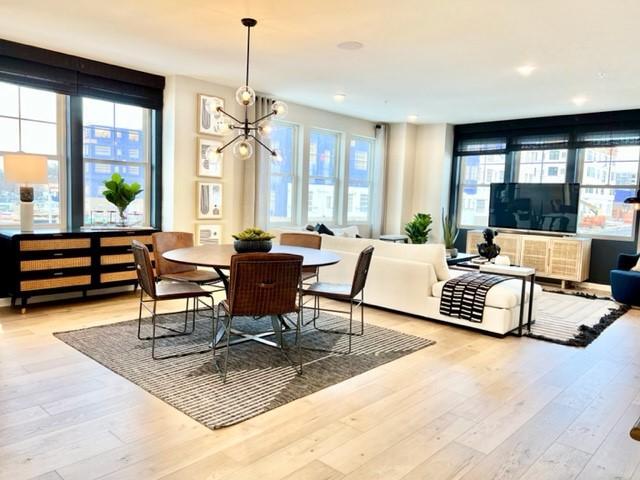 dining space featuring a chandelier and light hardwood / wood-style floors