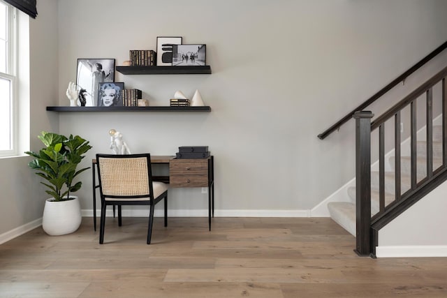 home office featuring hardwood / wood-style floors and a healthy amount of sunlight