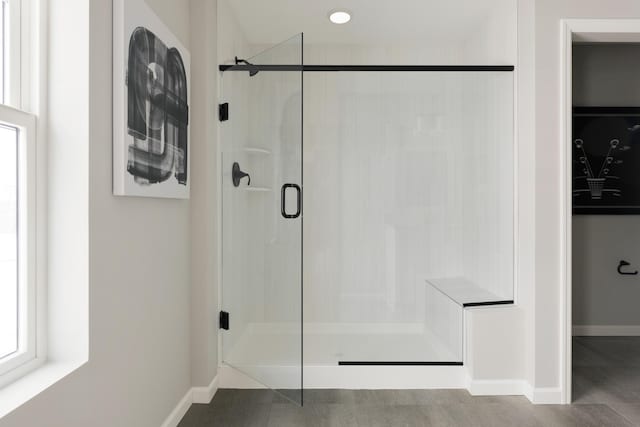 bathroom with tile patterned floors and a shower with shower door