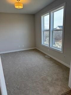 carpeted empty room featuring a healthy amount of sunlight