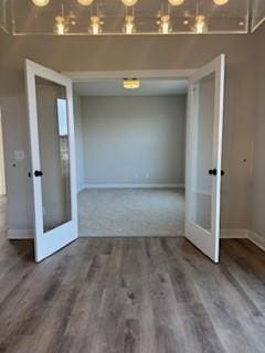 unfurnished room with hardwood / wood-style flooring and french doors