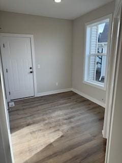 spare room featuring wood-type flooring