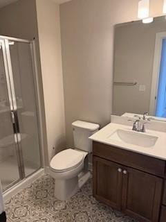 bathroom featuring vanity, toilet, and walk in shower