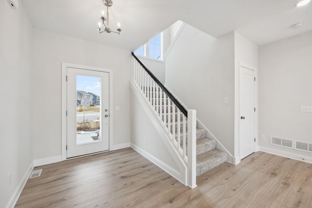 entrance foyer featuring a chandelier and light hardwood / wood-style floors