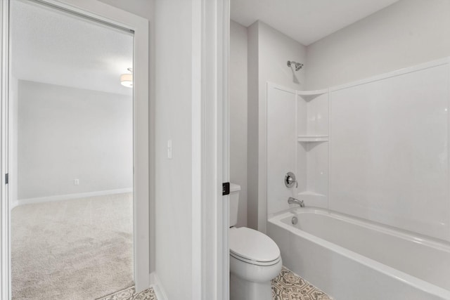 bathroom featuring shower / tub combination and toilet