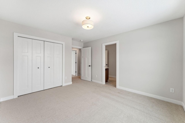 unfurnished bedroom featuring light colored carpet and a closet