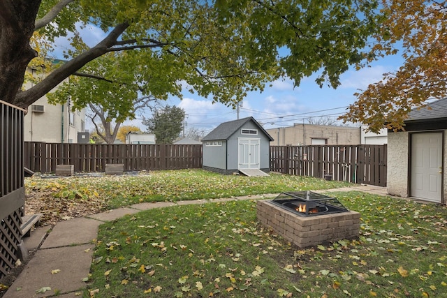 view of yard with a storage unit and a fire pit