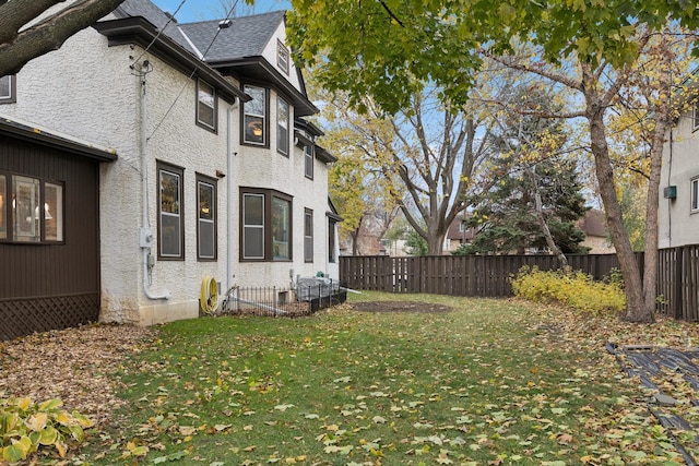 view of property exterior with a yard