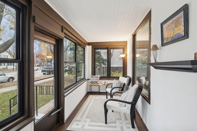 sunroom with a healthy amount of sunlight and wood ceiling