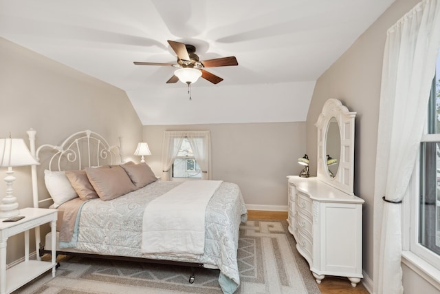 bedroom featuring ceiling fan and lofted ceiling