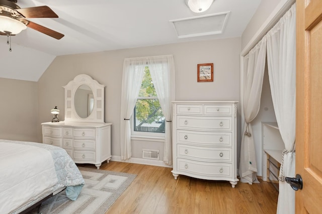 bedroom featuring ceiling fan, lofted ceiling, and light hardwood / wood-style flooring