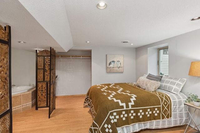 bedroom with hardwood / wood-style flooring