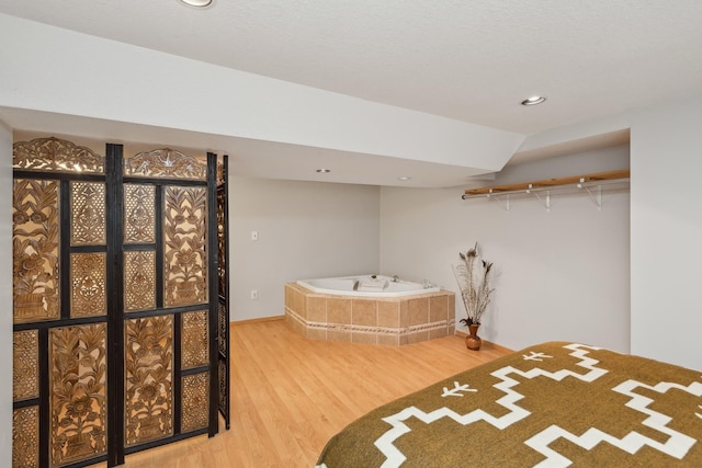 unfurnished bedroom with wood-type flooring and vaulted ceiling