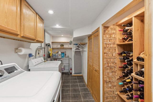 washroom with independent washer and dryer and cabinets