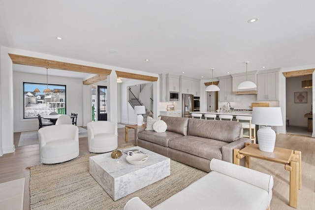 living room with stairway, light wood-type flooring, and recessed lighting