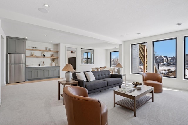 living area featuring recessed lighting and light colored carpet