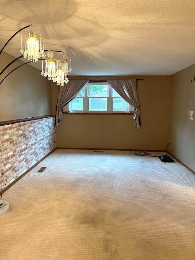 2402 Kenwood Dr SW, Willmar, MN 56201 - additional living space featuring carpet, a chandelier, a textured ceiling, and brick wall