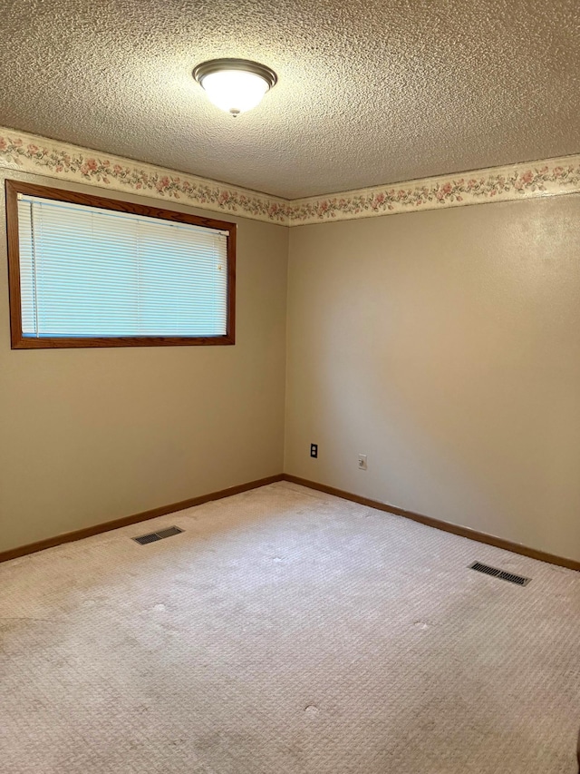 2402 Kenwood Dr SW, Willmar, MN 56201 - spare room with a textured ceiling and carpet flooring