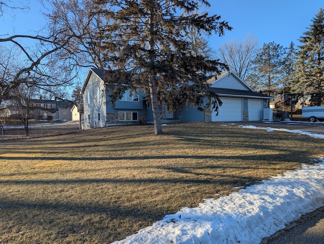 view of front of home featuring a garage and a lawn