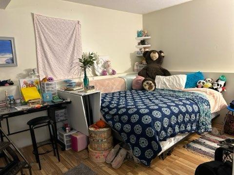 bedroom with wood-type flooring