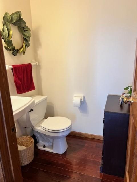 bathroom with toilet and hardwood / wood-style floors