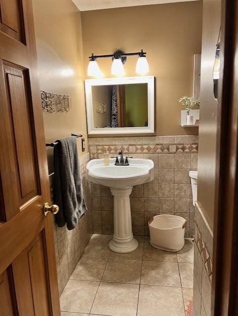 bathroom with tile walls and tile patterned floors