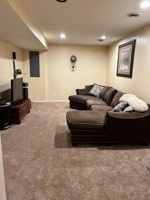 living room with carpet floors and electric panel