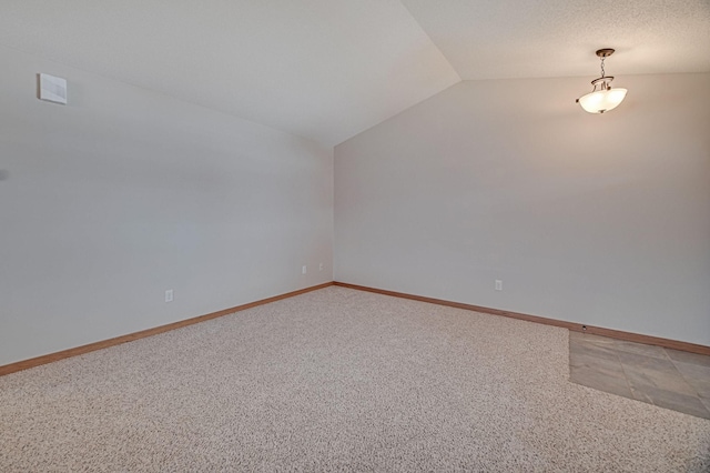 bonus room with lofted ceiling and carpet flooring