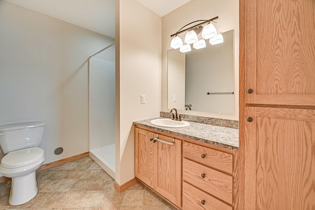 bathroom with toilet, a shower, and vanity