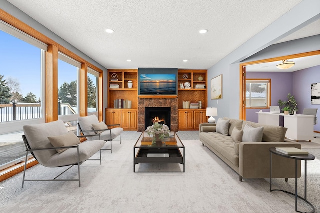 carpeted living room featuring a textured ceiling and built in features