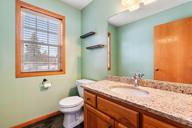 bathroom with toilet and vanity