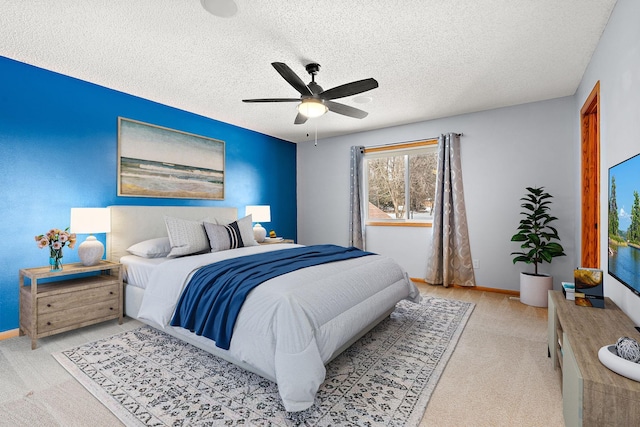 bedroom with ceiling fan and a textured ceiling