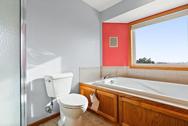 bathroom featuring a washtub and toilet