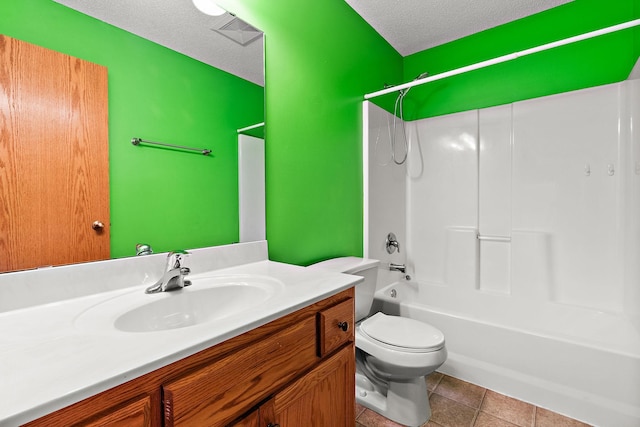 full bathroom with tile patterned floors,  shower combination, toilet, a textured ceiling, and vanity