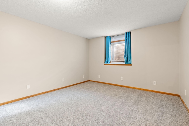 carpeted spare room with a textured ceiling