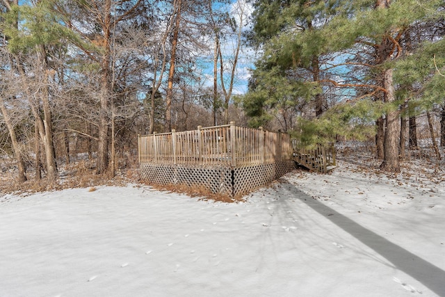 yard covered in snow featuring a wooden deck